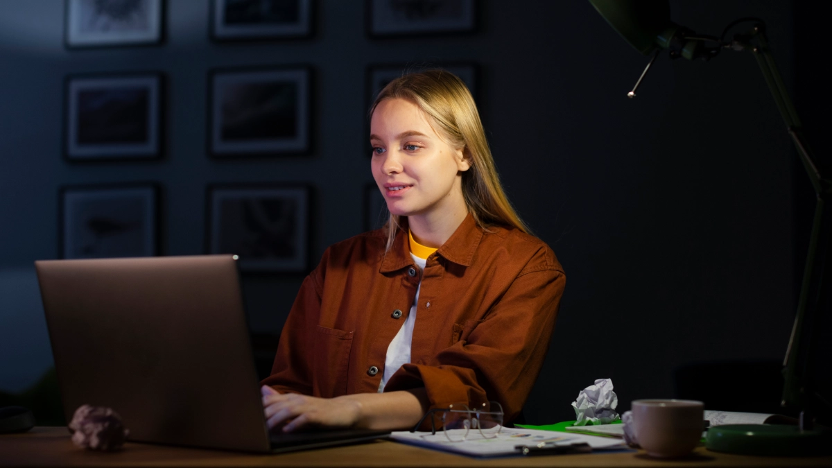 Woman looking at laptop in home office